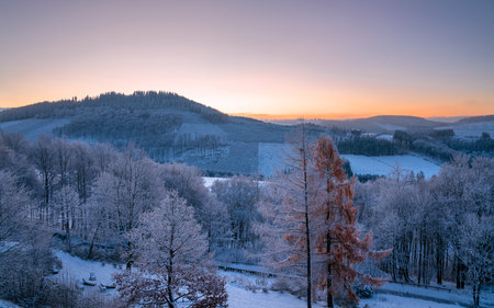 Panoramic image of winter landscape during sunrise, Schmallenberg, Sauerland, Germanyの写真素材