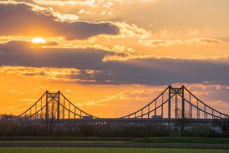 Old bridge crossing the Rhine river during sunset, Krefeld, North Rhine Westphalia, Germanyの写真素材