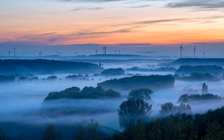 Evening mood, hills of Lower Rhine during sunset with evening fog, North Rhine Westphalia, Germanyの写真素材