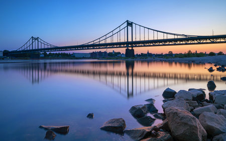 Old bridge crossing the Rhine river during sunset, Krefeld, North Rhine Westphalia, Germanyの写真素材