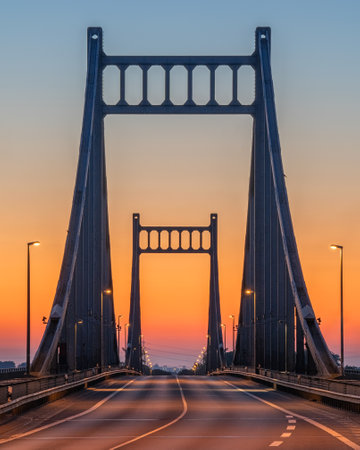 Old bridge crossing the Rhine river during sunrise, Krefeld, North Rhine Westphalia, Germanyの写真素材