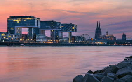 Panoramic image of modern buildings in the harbor of Cologne during sunset in Germany, Europeの写真素材