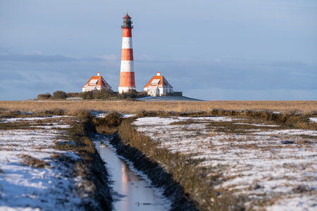 Panoramic image of Westerhever lighthouse during wintertime, North Frisia, Germanyの写真素材