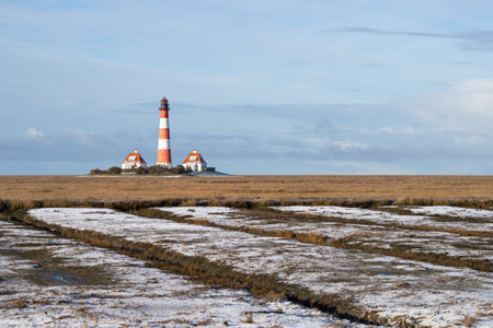 Panoramic image of Westerhever lighthouse during wintertime, North Frisia, Germanyの写真素材