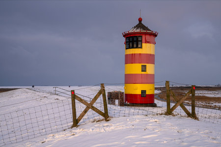 Pilsum, Germany - February 13, 2025: Lighthouse of Pilsum during sunset on February 13, 2025 in East Frisia, Germanyの写真素材