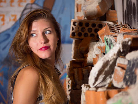 portrait blonde woman looking left behind himの写真素材