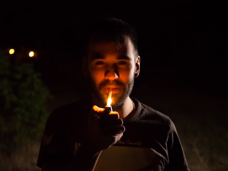 man smoking in the shadows