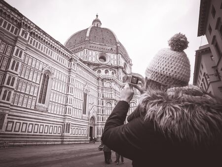 monochrome woman with hat taking pictures in Florence Italyの写真素材