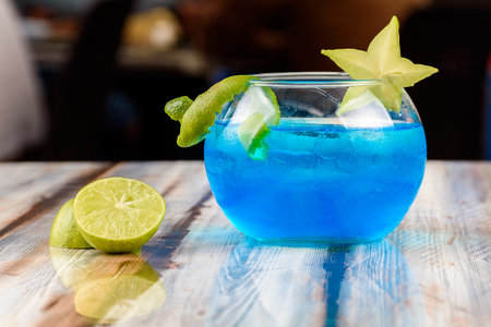 blue drink with kiwi and lemon served in a large glassの写真素材