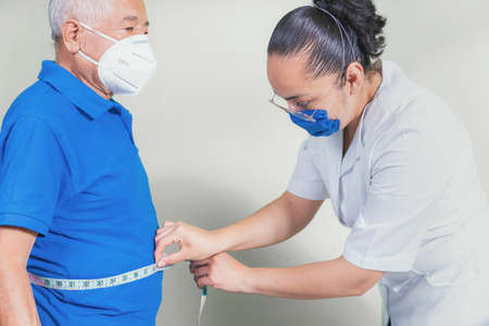 Senior man applying antibacterial gel on handsの写真素材