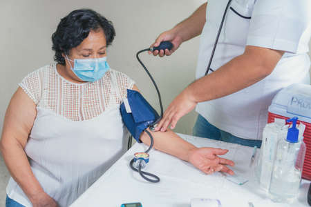 View of a senior woman's blood pressure check