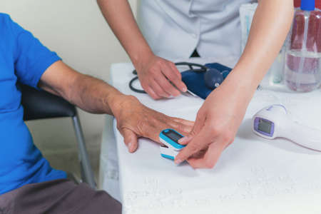 shows how to measure blood pressure in an older man