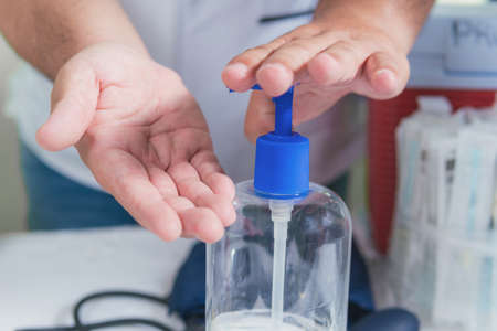doctor holds in his hands an instrument for measuring blood pressureの写真素材