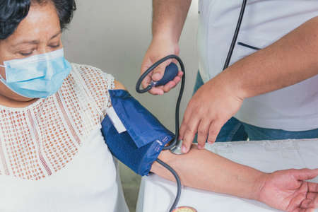 View of a senior woman's blood pressure check