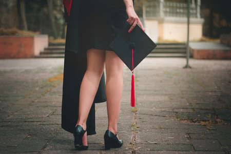 Shot from the back of a graduate, he is walking to attend the graduation ceremony at the university,...