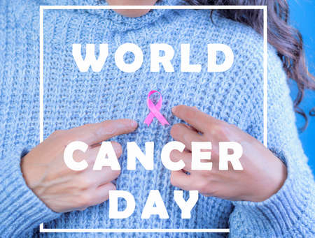 October Breast Cancer Awareness Month, Adult woman holding the Pink Ribbon to support people living...