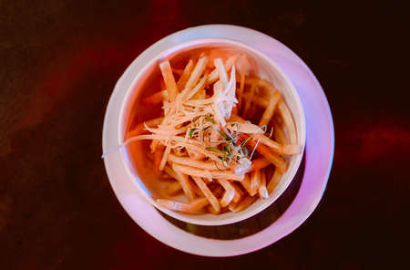 French fries with ketchup on wooden background.