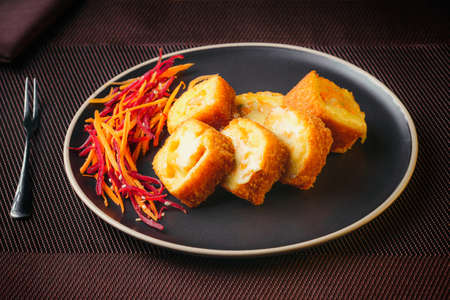 Plate of Japanese sushi rolls with tuna, crab, salmon, eel and gratin rolls, on a fine tableの写真素材