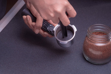Woman Barista operates a machine to prepare delicious coffee, Close-up of hands using the coffee...