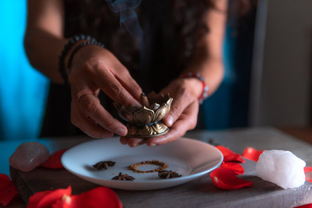 Close-up of hands lighting an incense, performing a cleansing ritual, spiritual beliefsの写真素材