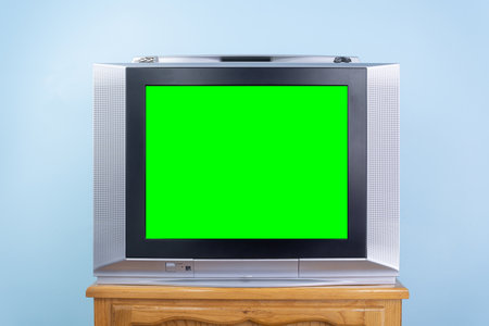 Old silver colored TV with green screen to add new images to the screen, Retro technology concept. Front view, close up, vintage antique television with green screen chroma key for designer. Antique TV, vintage technologyの写真素材