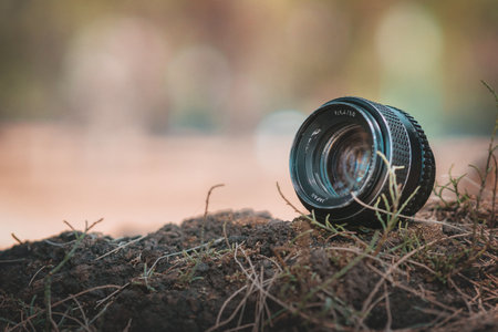 Retro camera lens sits on lawn has space for lettering, vintage conceptの写真素材