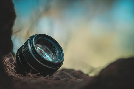 Retro camera lens sits on lawn has space for lettering, vintage concept