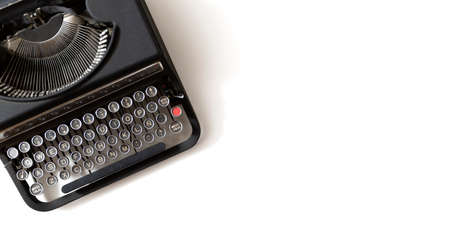 Retro black typewriter on white background with with copy space for text.