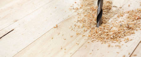 Detail of drill bit drilling natural wood slats. Space for text. Work and DIY concept.の写真素材