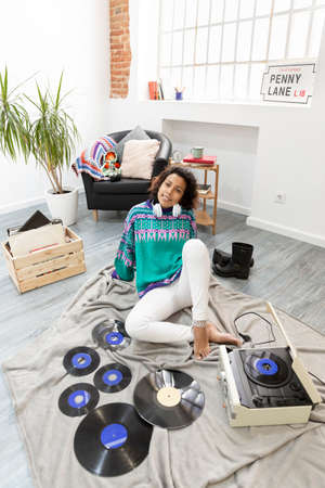 Young latina woman enjoying her free time at home. Space for text.の写真素材