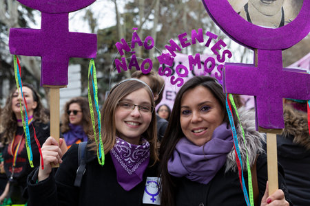 MADRID, SPAIN - MARCH 8, 2020: Two brazilian girls holding banner with the feminist symbol during the Women's Day demonstration in the city center of Madrid, Spain, on March 8, 2020のeditorial素材
