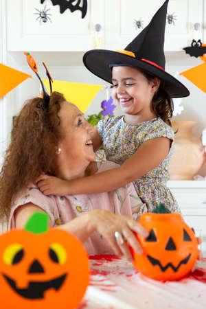 Grandmother and granddaughter having a fun time at Halloween party.の写真素材