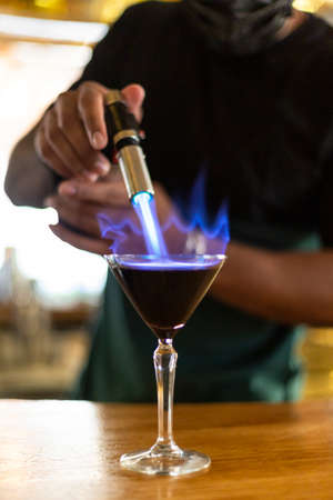 Close up of unrecognizable person preparing a cocktail.の写真素材