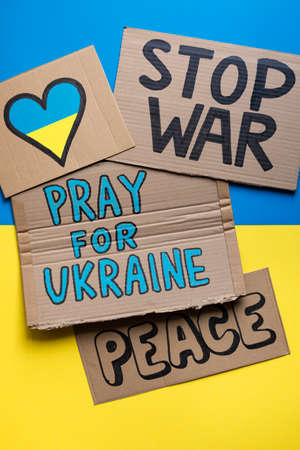 Different posters against the war between Russia and Ukraine on the Ukrainian flag.の写真素材