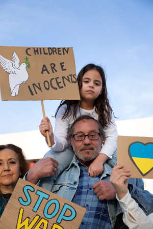 Group of demonstrators of different ages with anti-war banners. Protest against Russian intervention...