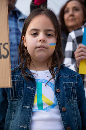 Portrait of little pacifist child during a protest against the invasion of Russian troops in Ukraine.の写真素材