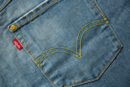 MADRID, SPAIN - APRIL 3, 2022: Close up of the back pocket of a pair of Levi's jeans with the classic embroidery and label of the world famous American clothing brand Levi Strauss & Co. Founded in 1853.のeditorial素材