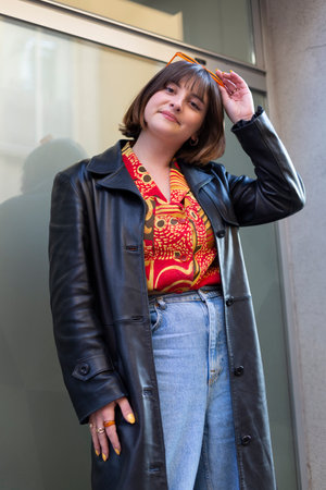 Outdoor portrait of a young caucasian woman with short hair and original way of dressing. Lifestyle and female fashion.の写真素材