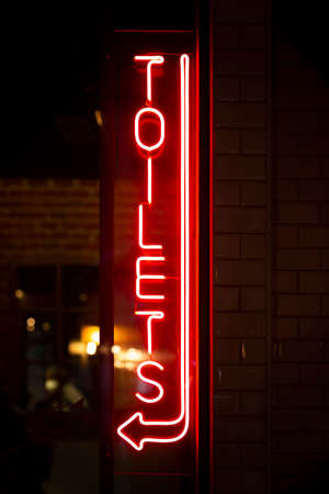 Neon sign with the word Toilets. Vertical-shot.の写真素材