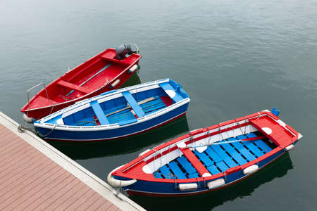 Colorful boats moored in fishing port. Top view, space for text.の写真素材