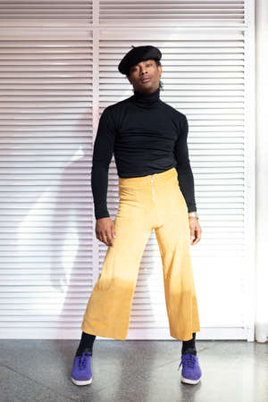 Young adult male African American dancer posing dressed in retro clothing. Disco fashion 70's.の写真素材