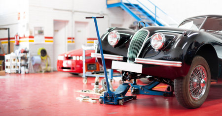 Panoramic view of the interior of a garage. Classic car being repaired. Space for text.の写真素材