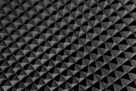 Acoustic insulation foam panel. Studio audio sound proofing. Dark background in the form of a pattern.の写真素材