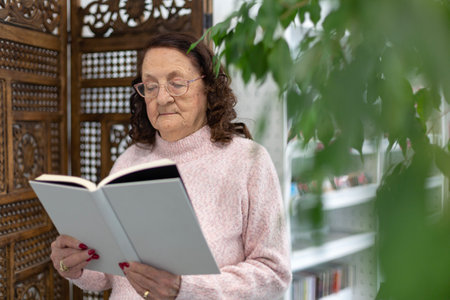 Caucasian elderly woman reading a book. Hobbies and entertainment for retired people.