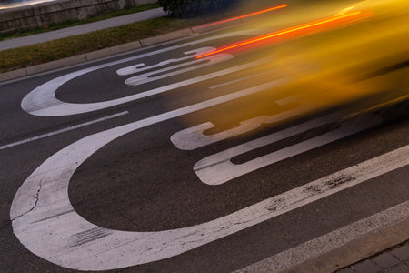 Acceleration of vehicle on speed limit sign. Image in movement, burst of light, wake of car.