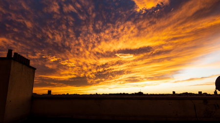Dramatic sunset with chimney pots in the foreground. Skylie of the city.の写真素材