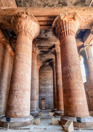 Columns with hieroglyphs and polychromy at Edfu Temple showing, Dedicated to the Falcon God Horus, Located on the west bank of the Nile, Edfu, Upper Egyptのeditorial素材
