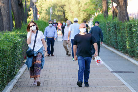 Huelva, Spain - May 5, 2020: People going out for a walk wearing protective or medical face masks during the alarm state and quarantine in Spain.のeditorial素材