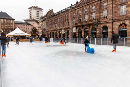 Strasbourg, France - december 1,2019: People ice skating in kleber square during a beautiful Christmas day winter. People are enjoying this typical Strasbourg winter activityのeditorial素材