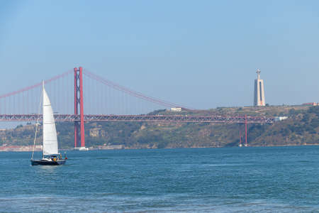Sailboat with 25th April bridge  in the background 